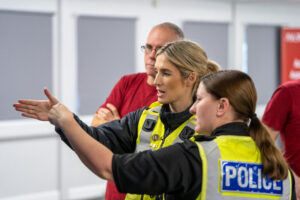 Two Law Enforcement Officers conversing over a scenario happening within the virtual reality software