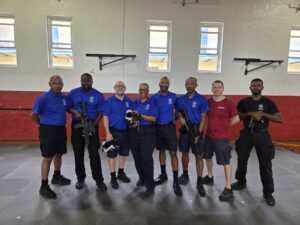 Bermuda Police Service officers with the AVRT team, holding tracked weapon surrogates and a VR headset following their system deployment